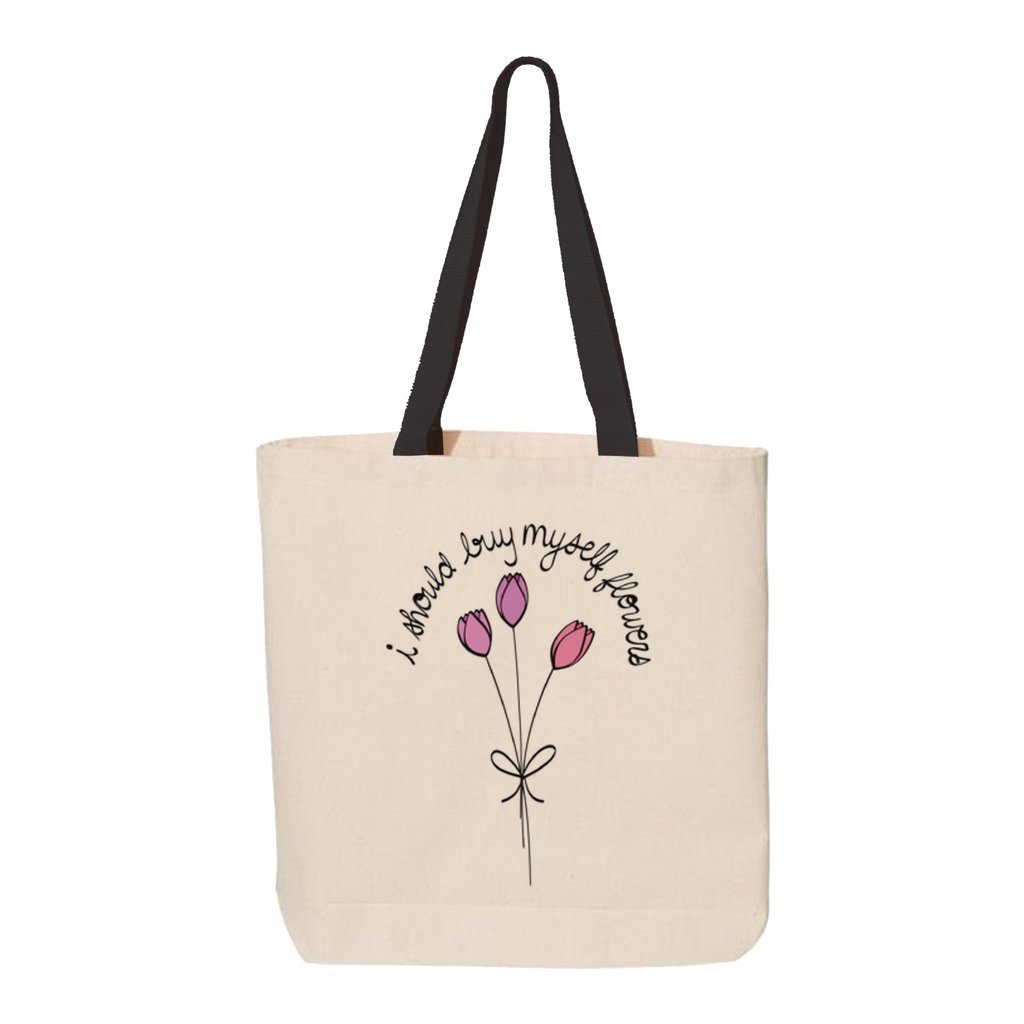 Tan canvas tote back with pink and purple flowers printed on front